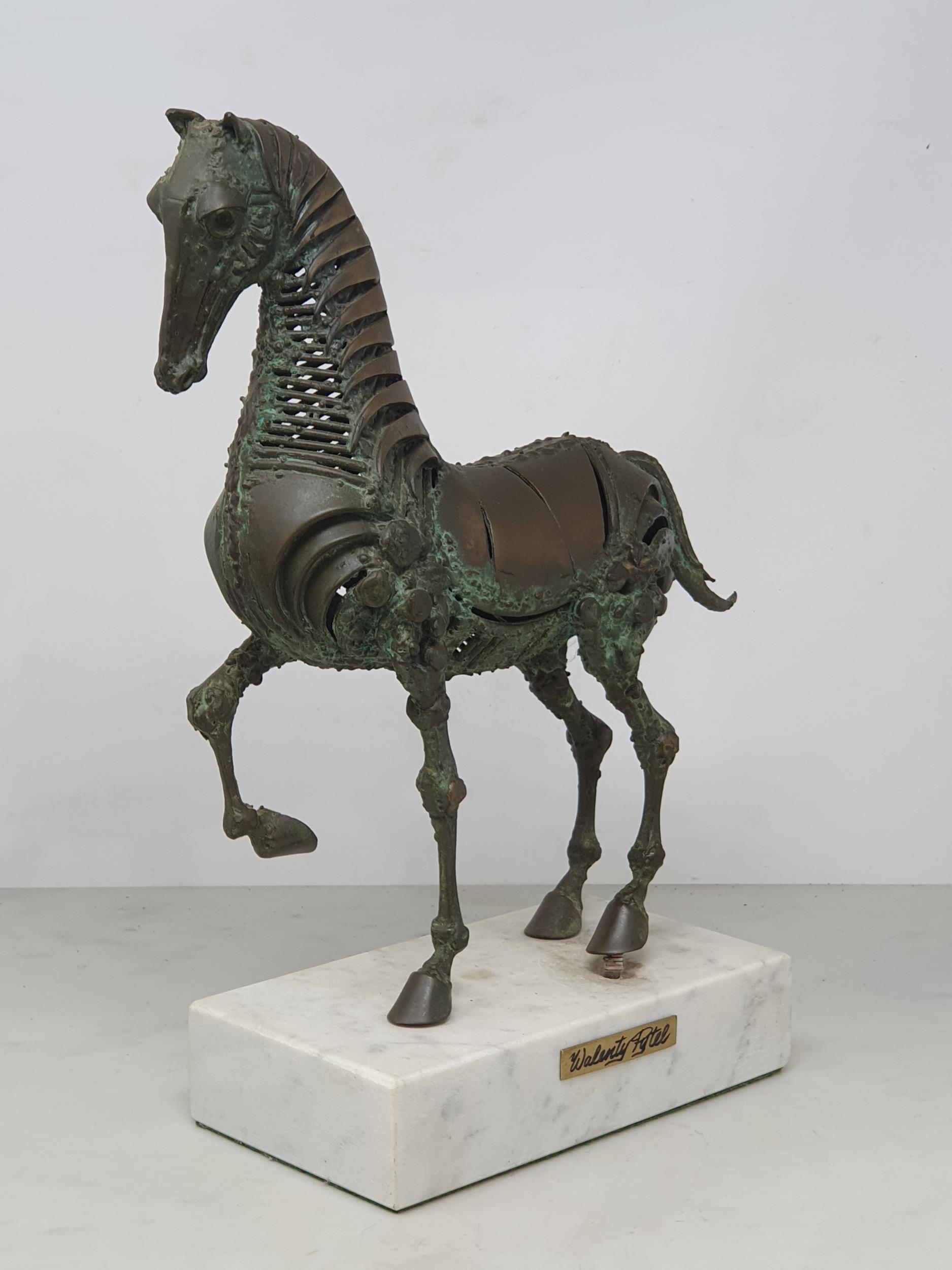 WALENTY PYTEL. A patinated bronze Sculpture of a prancing horse, mounted on a white rectangular