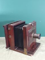 A mahogany 8 x 8in mahogany and brass mounted large format Camera with indistinctly signed lens, the