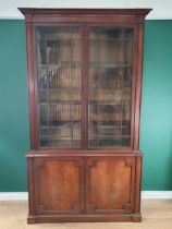 A 19th Century mahogany Glazed Bookcase, the moulded cornice, above pair of glazed doors enclosing