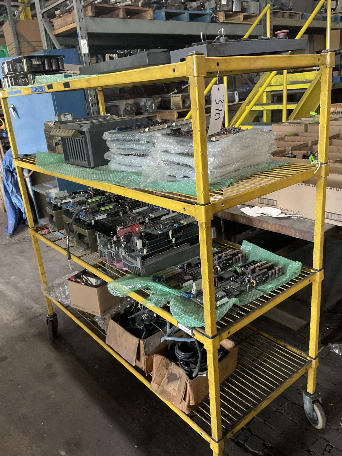 Yellow cart of Mazak Repair Parts with contents