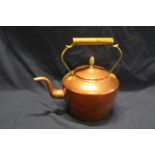 A vintage copper and brass kettle