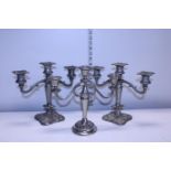 A pair of plated candelabra's and one other