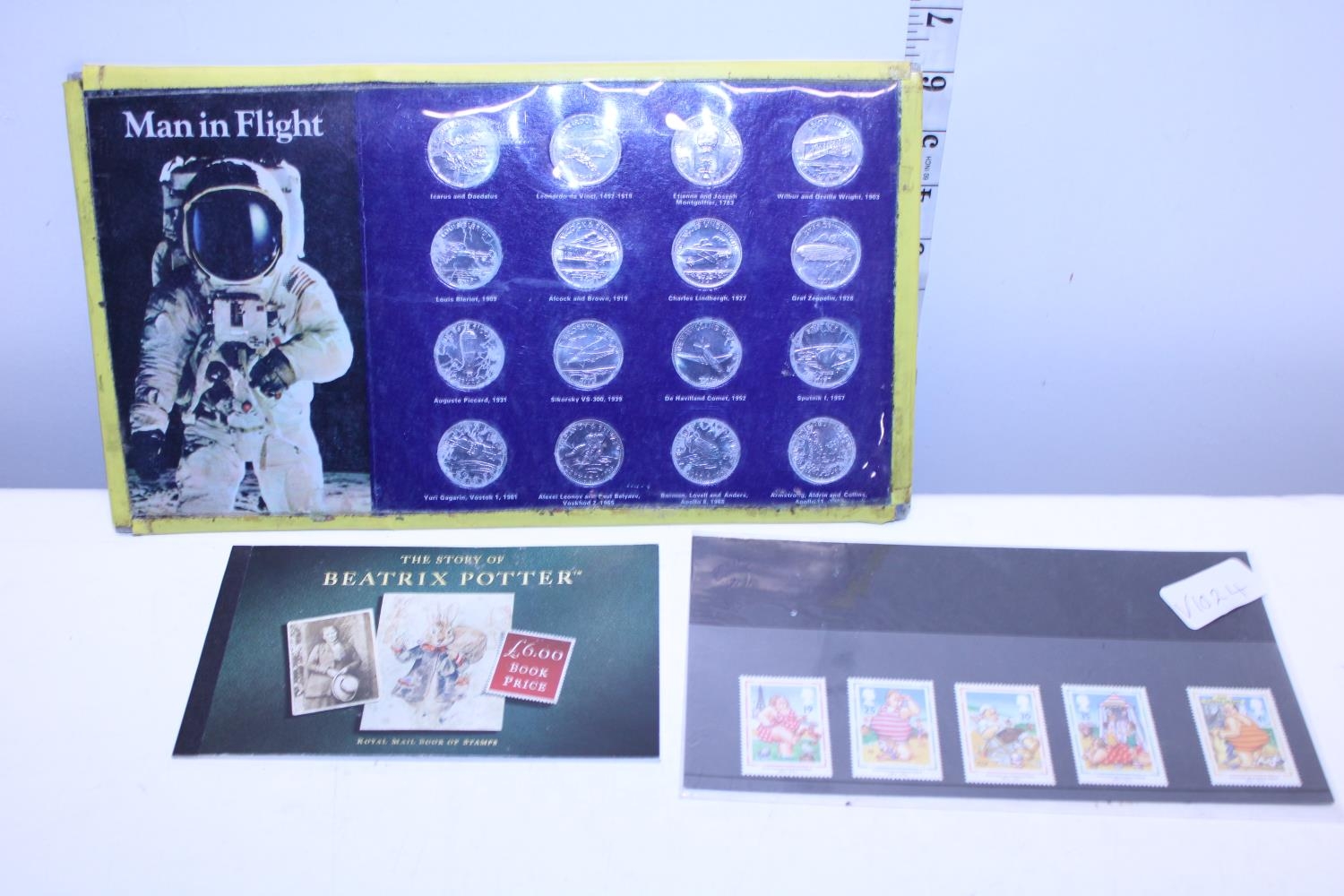 A vintage man in flight coin set and a selection of first day cover stamps