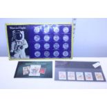 A vintage man in flight coin set and a selection of first day cover stamps