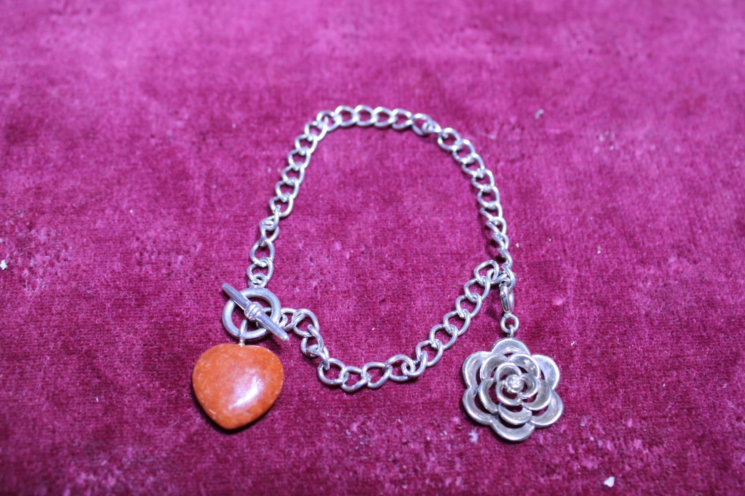 A hallmarked silver bracelet with charm