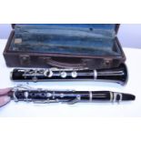 A antique cased clarinet made by Couesnon of Paris, mouth piece not original.