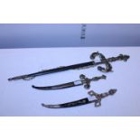 Three novelty daggers with scabbards