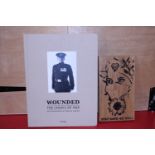 A Wounded Legacy of War book photographs by Bryan Adams and a Veterans wooden crafted plaque