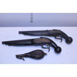 Two vintage wall hanging flintlock pistols and a antique powder flask