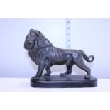 A hollow cast bronze lion on plinth