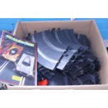 A box of vintage Scalextric track and accessories