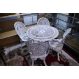 A white metal garden table and four matching chairs, shipping unavailable
