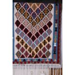 A large hand woven Persian rug approximately 210cm x 96cm