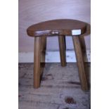 A vintage Robert 'Mouseman' Thompson three legged stool with kidney shaped seat