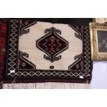 A hand woven small Persian rug approximately 145cm x 85cm