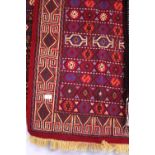 A small hand woven Persian rug approximately 112cm x 75cm