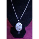 A sterling silver chain and locket
