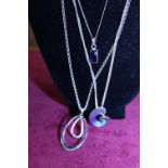 Three sterling silver necklaces with pendants