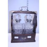 A vintage two decanter Tantalus with key