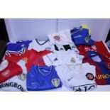 A large selection of assorted football shirts