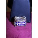 A antique white metal salt with enamel decoration and glass liner