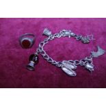 A sterling silver chain and white metal charms and a sterling silver ring