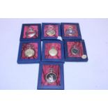 Seven assorted boxed collectable pocket watches