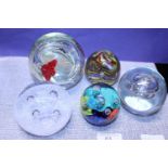 Five assorted glass paperweights