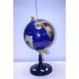 A semi-precious stone globe on stand. postage unavailable.