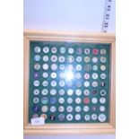A cased collection of golf ball markers 31cmX31cm