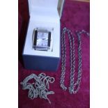 A boxed Kenneth Cole reaction watch and selection of silver plated chains