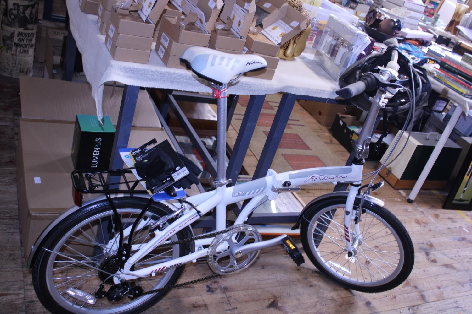 A Falcon foldable bike with accessories. postage unavailable.