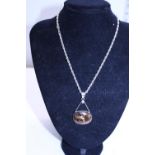A 925 silver chain and silver mounted tigers eye pendant