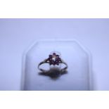 A hallmarked 9ct gold ruby and diamond solitaire ring