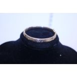 A 9ct gold bangle (small dent) 11g