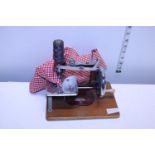 A vintage child's toy sewing machine