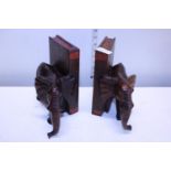 A pair of elephant themed wooden book ends
