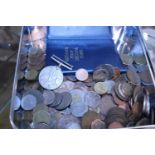 A tin of assorted world coinage and other