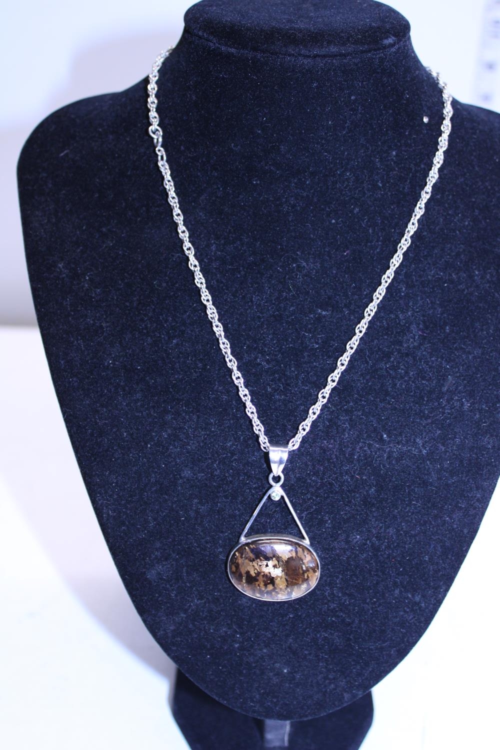 A 925 silver chain and silver mounted tigers eye pendant