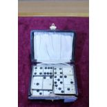 A box of antique bone faced dominoes