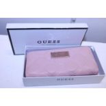 A boxed Ladies Guess purse