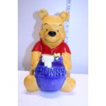 A large Disney Winnie the Pooh ceramic money box