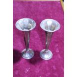 A pair of hallmarked silver trumpet vases (one has a dent)