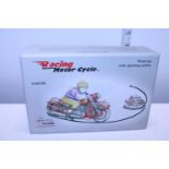 A vintage style boxed tin plate wind up motorbike