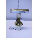 A brass bankers style desk lamp