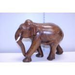 A heavy dense wood, large carved elephant (missing one tusk)