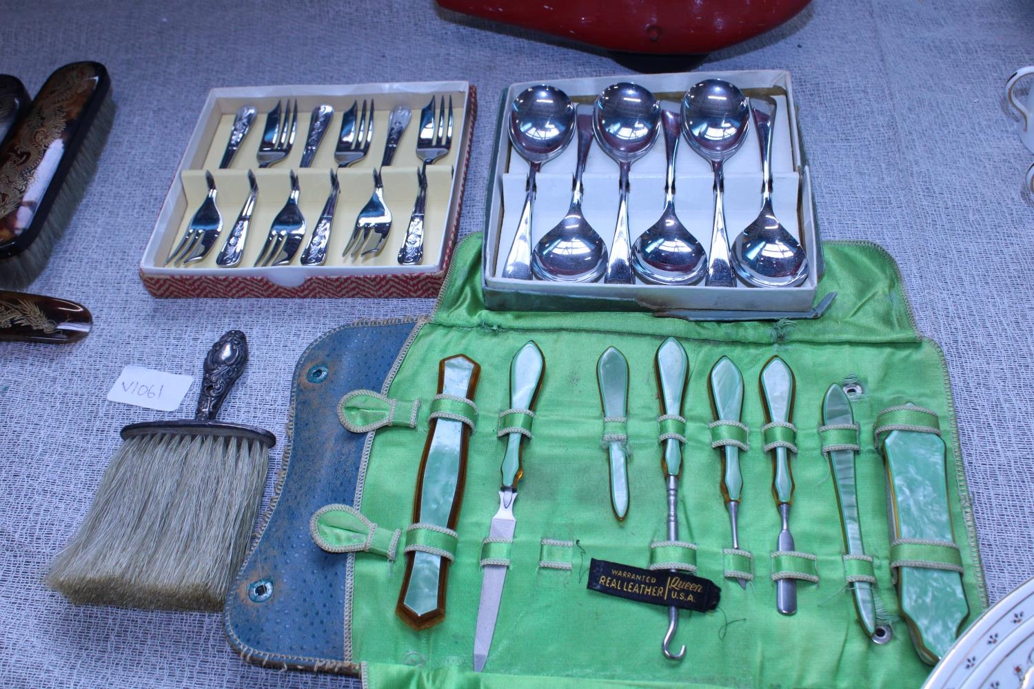 A selection of vintage cutlery and manicure set with hallmarked silver brush