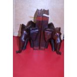 Two carved wooden elephant form book ends