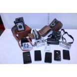 A selection of vintage cameras and mobile phones