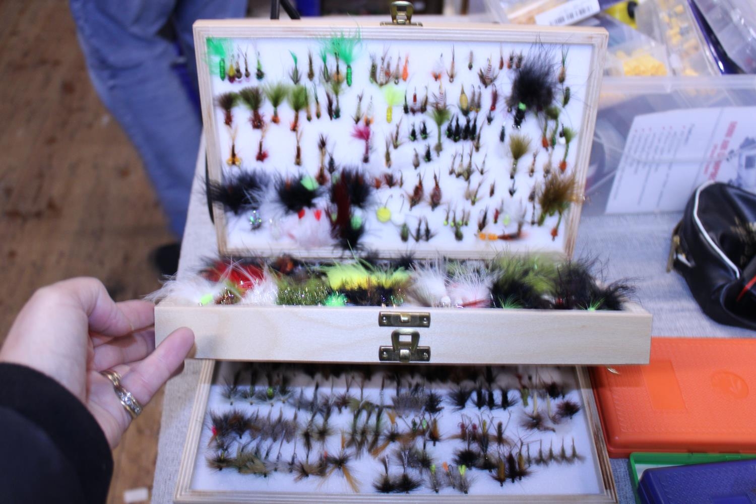 A comprehensive box full of hand tied fly fishing flies